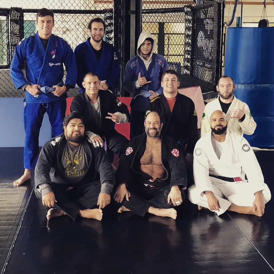 Team Santos coaches and members on the mats